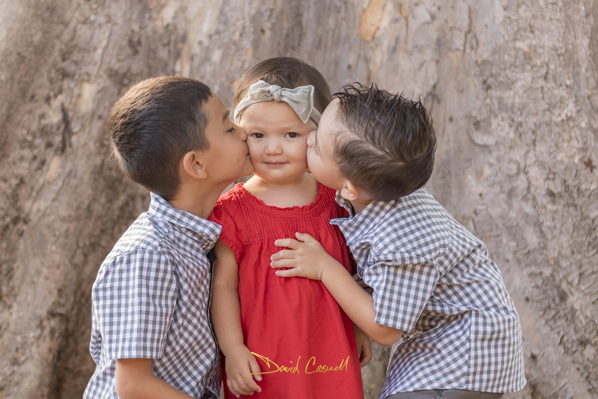 Siblings kissing in Kahala, Hawaii